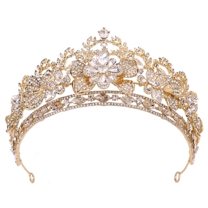 Close-up of luxury gold bridal crown with leaf patterns and shimmering crystal rhinestones