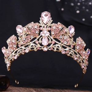 Detailed macro view of luxury gold crown with pink crystals and intricate floral patterns