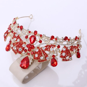 Detail of baroque gold bridal crown with red teardrop gemstones and crystal inlay