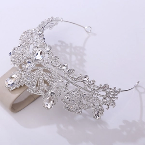 Close-up of luxury silver crown with clear crystals and hollow leaf-shaped patterns