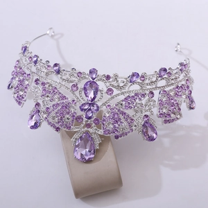 Detailed macro view of wedding tiara featuring purple teardrop crystals and silver metal