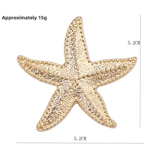 Detailed view of starfish brooch with golden texture and 5.2cm size measurements