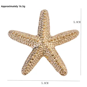 Detail view of a 5.8cm gold starfish brooch with textured surface and size measurement
