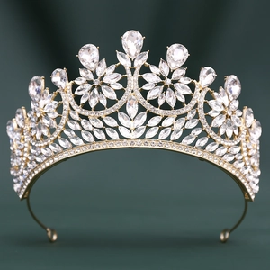 Detailed view of ornate golden bridal tiara with sparkling crystal flower patterns