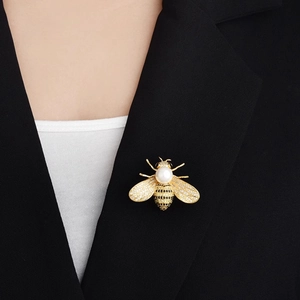 Luxury honey bee brooch for women with white pearl and sparkling crystals on a black blazer