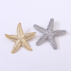 Vintage starfish brooch set in gold and silver finish with sparkling white crystals