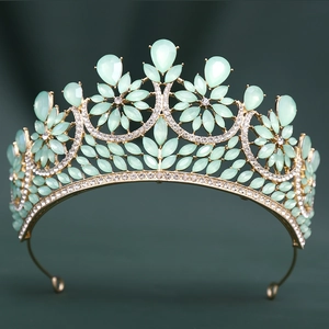 Detailed view of mint green crystals and droplets on a golden baroque tiara