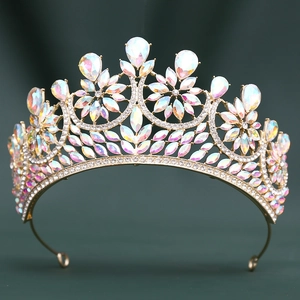 Golden baroque bridal crown with colorful AB rhinestones on a dark teal background
