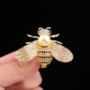 Luxuriöse goldene Bienenbrosche mit funkelnden Kristallen und einer gelben Perle