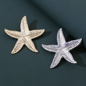 Vintage starfish brooches in gold and silver finish with detailed textured surfaces