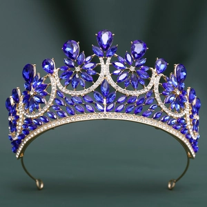 Detailed close-up of Baroque gold crown featuring royal blue crystals and small white diamonds