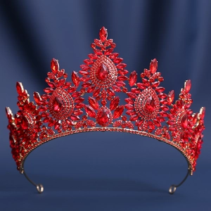 Close-up of golden bridal crown featuring vibrant red crystals and teardrop gems