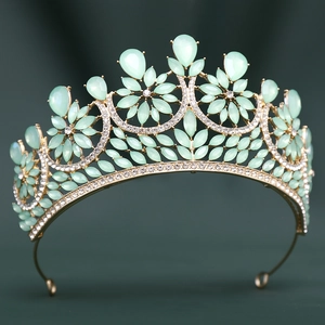 Detailed front view of gold bridal crown featuring mint green gems and crystal accents