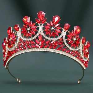 Close-up of golden bridal tiara featuring red water-drop rhinestones and intricate crystals