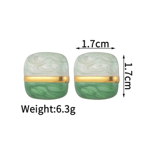 Détail de boucles d'oreilles carrées en émail de 1,7 cm avec texture marbrée verte