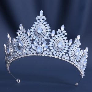 Elegant silver Baroque bridal crown with blue crystals on dark blue velvet background