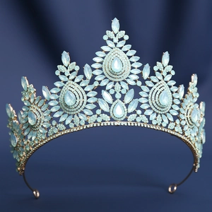 Detailed macro view of blue crystals and gold alloy bridal crown on blue background