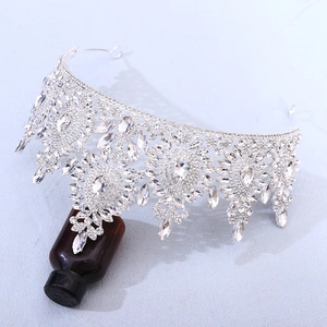 Detailed close-up of a silver bridal tiara featuring pear-cut rhinestones and floral alloy patterns