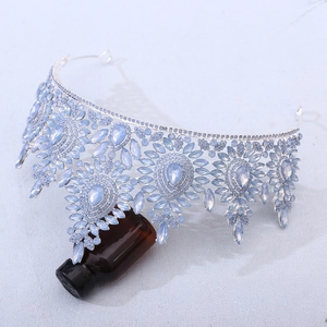 Macro shot of silver bridal crown featuring light blue marquise-cut crystals and metal lattice