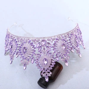 Macro detail of Baroque silver crown with purple rhinestones and water drop crystals