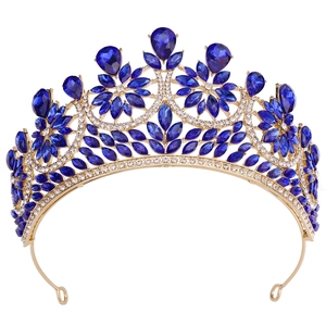 Detail of golden bridal tiara featuring blue teardrop crystals and white rhinestones
