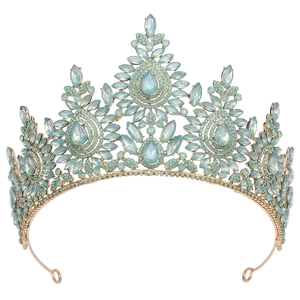 Macro view of a gold vintage crown set with pale blue gemstones and detailed crystals