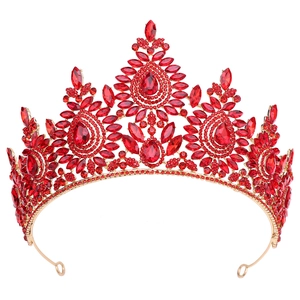 Detail view of the ornate golden frame and sparkling red crystals on the bridal crown