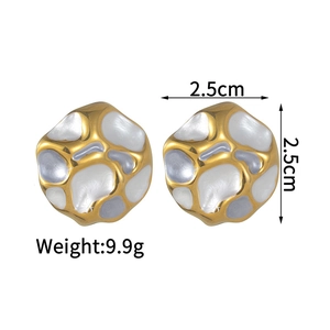Detailed view of gold earrings with irregular white enamel texture and size marking