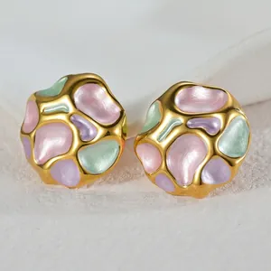 Detail of irregular pleated earrings with colorful enamel inlay on gold metal base