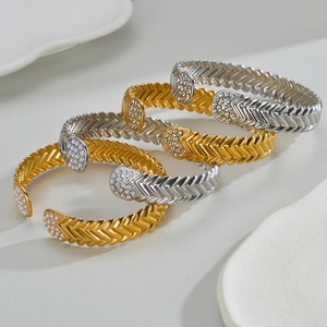 Minimalist snake-style open cuffs in gold and silver with inlaid pearls and zircon stones