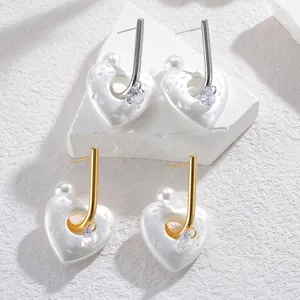Orecchini a cuore traforato con perle e strass in finitura dorata e argentata