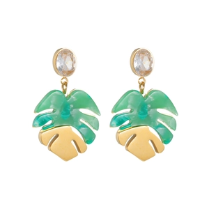 Detail of tropical monstera leaf earrings with green resin and gold-plated metal