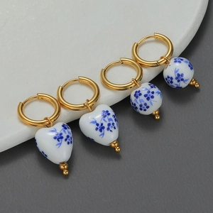 Blue and white porcelain heart and bead earrings with gold hoops set in a pair