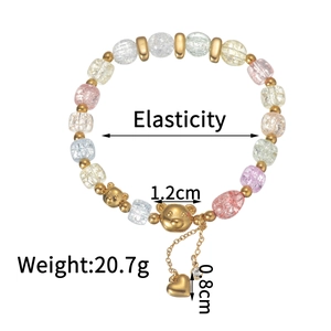 Detail view of colorful cracked glass bead bracelet with gold bear and heart pendants