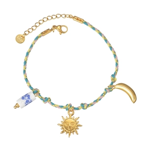 Colorful braided bracelet with sun pendant and porcelain beads on white background