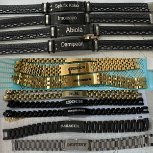 Custom engraved stainless steel bracelets with heart icons and braided leather straps