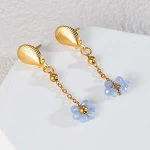 Detail of long drop flower earrings with blue beads and shell embossed studs