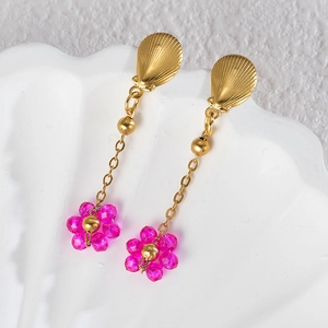 Detailed close-up of beaded flower earrings with gold scallop stud on white shell