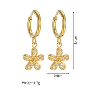 Detail view of gold hoop earrings with sparkling crystal flower pendants and size dimensions