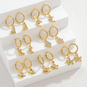 Detail of 14-piece 18K gold plated hoop earrings set with crystal crown heart charms