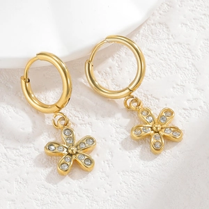 Macro shot of gold-plated crown heart earrings with sparkling white cubic zirconia stones