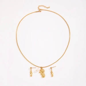 Golden seahorse jewelry set featuring necklace and stud earrings with white pearl accents