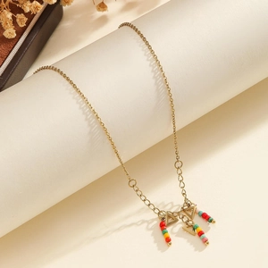 Detail of gold chain necklace with colorful beads and hollow triangle charm tassels