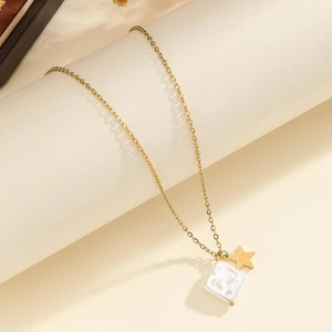 Detail of gold star and marble texture square pendant on a thin stainless steel necklace