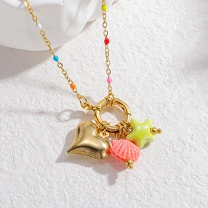 Detail of colorful beads with golden heart shell and star pendants on a beach style necklace