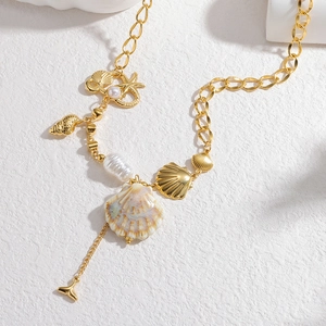 Golden ocean shell necklace with baroque pearls, starfish charms and whale tail pendant