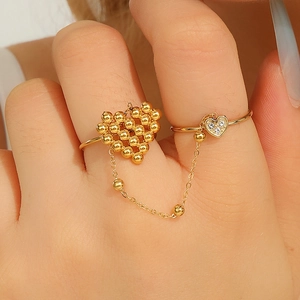 Vintage gold layered chain ring featuring heart charms and cubic zirconia accents
