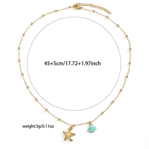 Detail of 45+5cm bead chain with starfish and turquoise fish charms for women