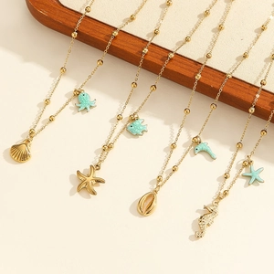 Marine themed necklace set with gold seahorse and starfish pendants on a wooden stand