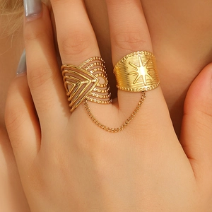 Detail of gold chain link ring featuring bohemian hollow design and star engraved pattern
